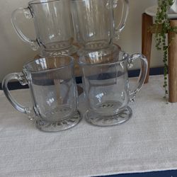 Libbey heavy clear glass mug with a decorative handle and pedestal base. 