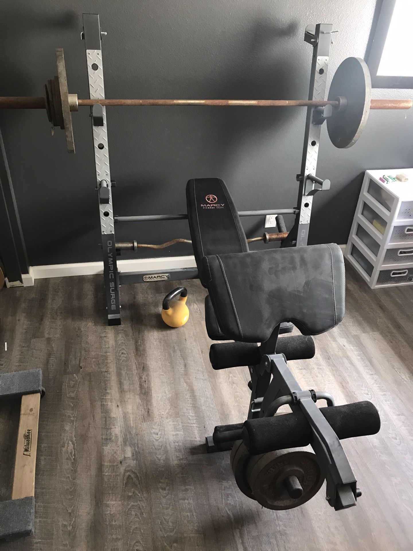 Marcy Olympic surge weight bench with 45 lb bar, curl bar and 250lbs of