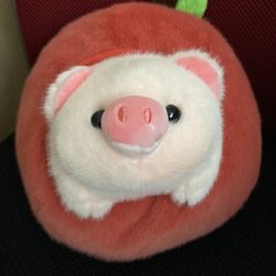 piggy stuffed animal with an apple plush toy