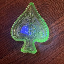 vintage uranium glass trinket dish in the shape of a playing card spade. 