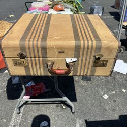 vintage striped suitcase from the mid-20th century, likely produced by Hartmann Luggage. It features a tan tweed-like canvas exterior with brown and g