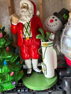 38” lg Santa golfing sculpture some nicks in pictures can be painted over weighs 24 lbs
