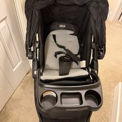 Black Chicco Bravo stroller with cup holders and storage.