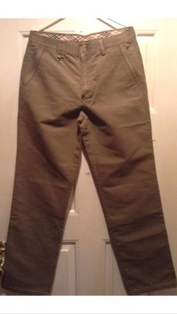 Pre owned size 34 khaki Burberry London pants women's In very good condition with Burberry emblem on back right pocket