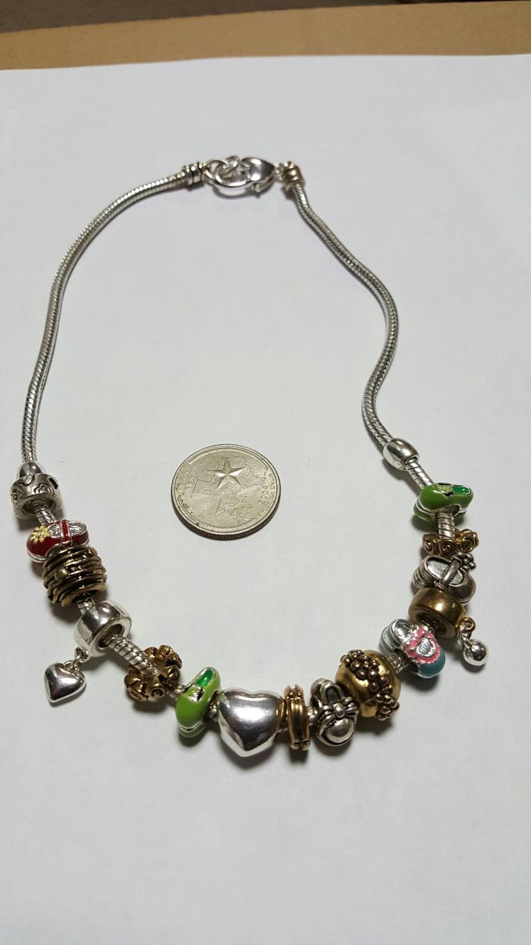 New silver plated necklace with charms.