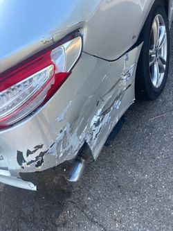 Silver Sedan with Rear Bumper Damage