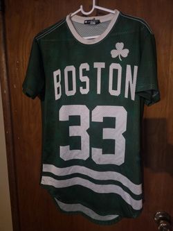green Boston Celtics #33 mesh jersey features a unique short-sleeve styling with a shamrock graphic and wave hem detail