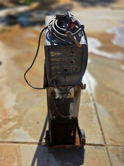 Miller Millermatic 135 115V MIG wire welder with rolling welding cart.