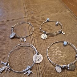 Four Bangle charm bracelets with.925 Sterling silver charms