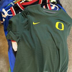 Bundle of 8–9 Sports Jerseys & T-Shirts – sizes, good condition. Includes Nike, NBA, and more. 
