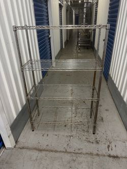 4 Tier Metal Adjustable Shelves  36” wide  14” deep  54” tall  Rusty but still Sturdy. Good for garage or shed