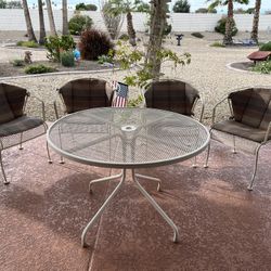 Metal patio table and 4 wrought iron chairs