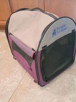 Portable pet home by PetMete roll up shades on four sides zippered closures. There are tabs on the bottom to secure it to the ground if you're camping