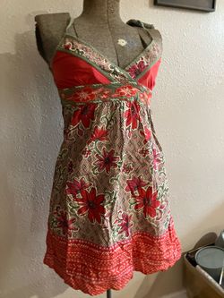 red and beige floral print camisole top with green trim.