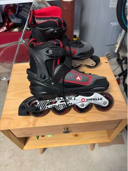 Women’s red and black air walk skates
