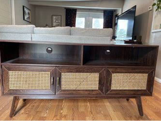 mid-century modern TV stand with cane/rattan doors.