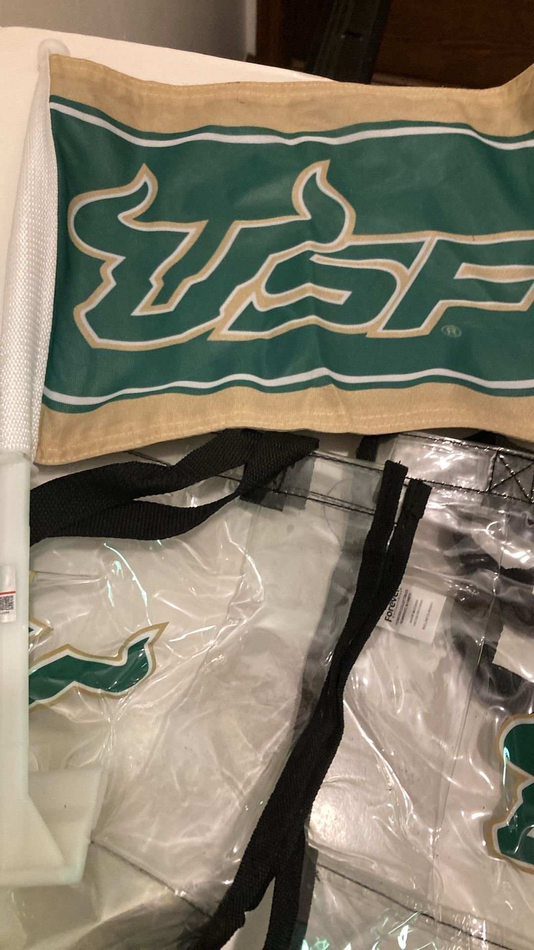 Five pieces of USF, swag memorabilia, including a flag to clear bags and too many towel