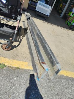 2 aluminum loading ramps with a diamond plate surface. 7' each