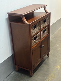 Pier 1 imports furniture Solid wood traditional dark wood storage cabinet featuring an open upper shelf, four woven wicker or rattan storage baskets, 