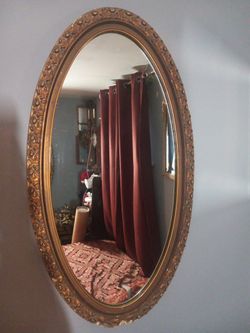 Large Antique Wall Hanging, Gilt Gold,Oval Shape,Floral Design Wooden Frame. 
Normal wear and tear. Nick's,dents and scratches MAY be seen.  Cleaning 