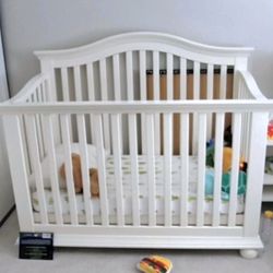 Beautiful White Solid Wood Crib/Toddler bed. Adjustable height, good condition.