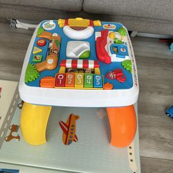 Fisher-Price Baby to Toddler Toy Laugh & Learn Around the Town Learning Activity Table with Music & Lights for Infants Ages 6+ Months​ (Amazon Exclusi