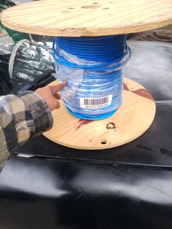 Blue Wire Spool on Wooden Reel