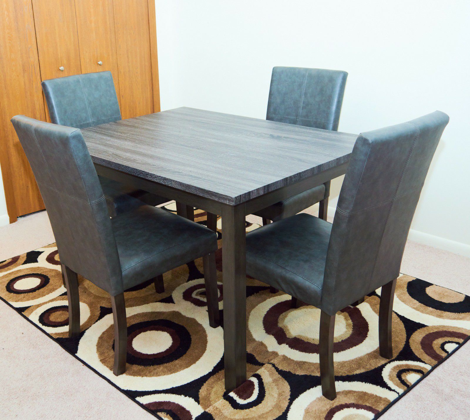Casual dining table with 4 faux leather upholstered chairs