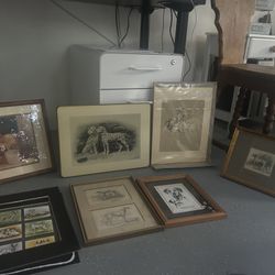 An assortment of original artwork featuring a soldier on a horse and dalmations