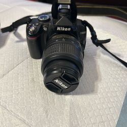 NIKON D3000 CAMERA WITH EXTRA LENS . COMES WITH NEW 32 GB SD CARD AND BATTERY CHARGER .