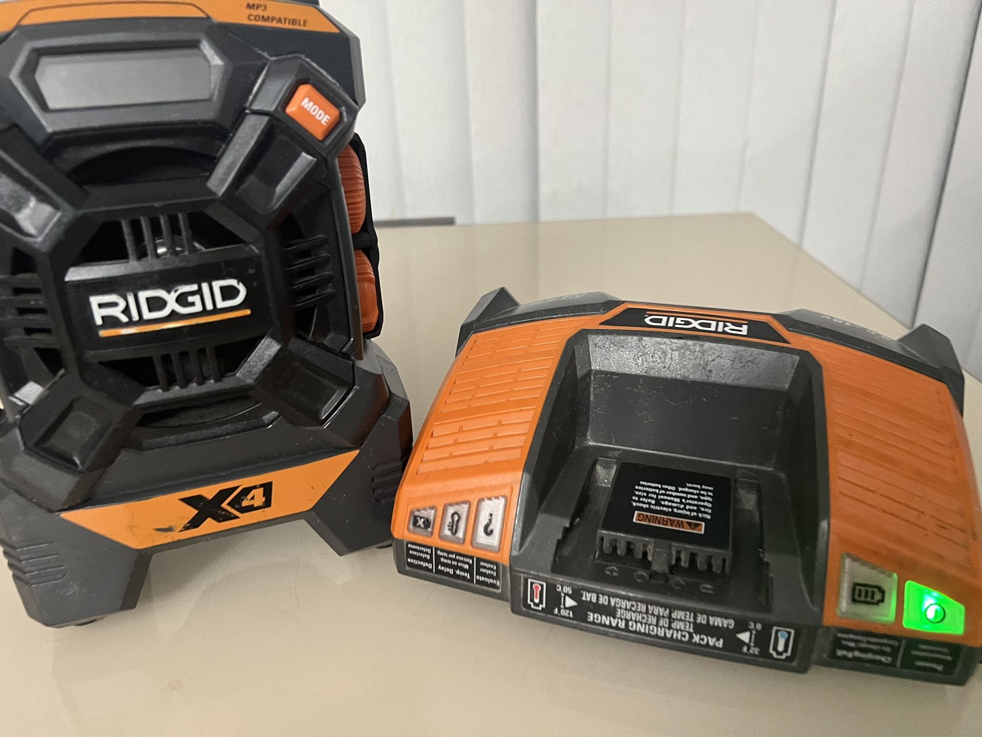 Rigid Jobsite Radio R84084 X4 MP3 AM FM & R840093 Charger only (No Battery). Both items works perfectly. The both have cosmetic blemishes from usage.