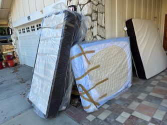 Two Twin size box springs and 1 full size mattress