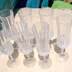 Two Different Sets Of Wine And Champagne Glasses.