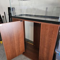 20 Gallons Long, Breeding Fish Tank. Minor Maintanance Scratches. Glass Lid. Stand Included(wood)