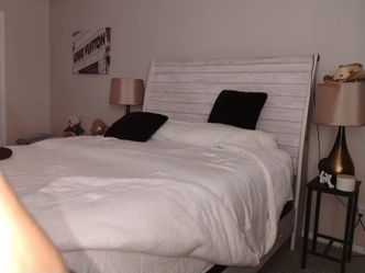 Bed and pictures also table and lamps
