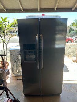 Frigidaire side-by-side refrigerator with icemaker and water dispenser