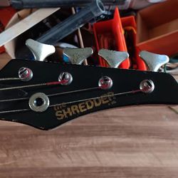 The shredder, black electric Base guitar.
