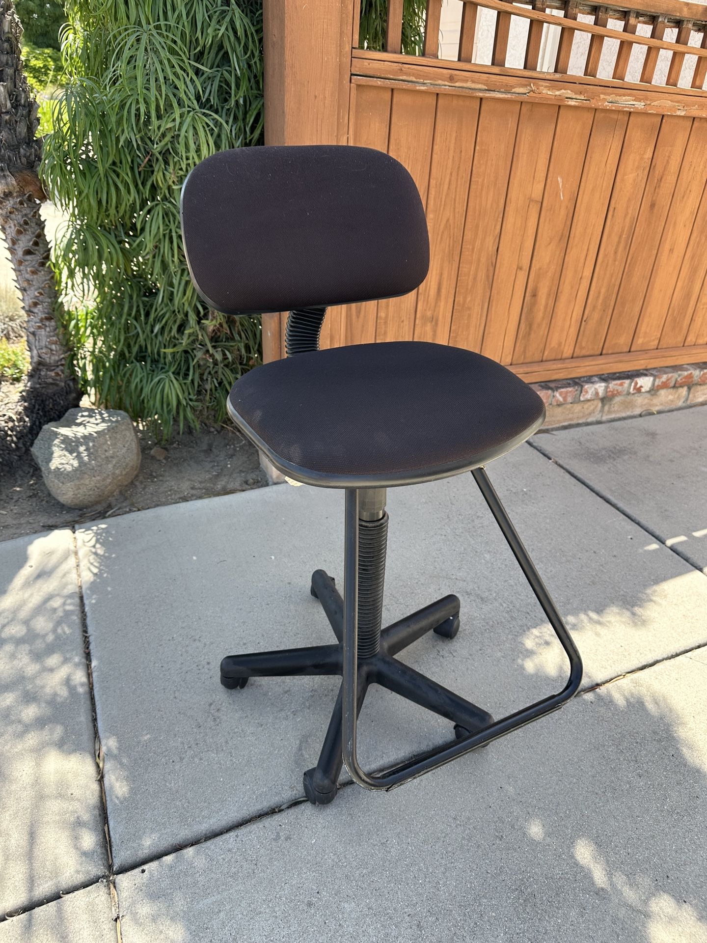 Comfortable swivel stool on rollers with foot rest