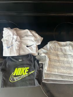New born Nike onesies and CK 0-3 month onesies