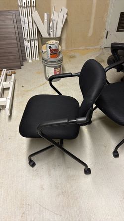 Black cushion office chairs on wheels