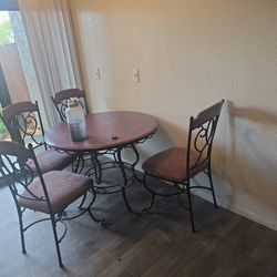 Wooden And Steel Chairs And Round Dinner Table