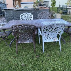 Outdoor/Patio metal large heavy table with six chairs. Needs fresh paint 