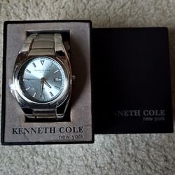 Men's Large Face Kenneth Cole Watch still has protective coating on face. needs battery. See our other great vintage jewelry art comic books VHS movie