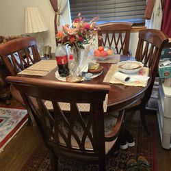nice round dining table and 6 chairs 