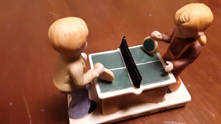 Porcelain figurines kids playing ping pong