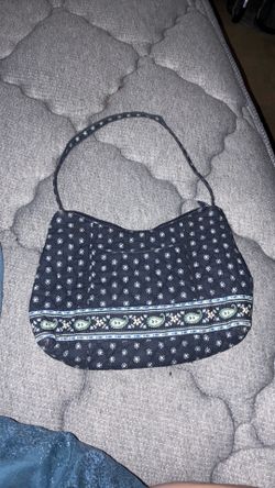 Vera Bradley shoulder bag features a quilted navy fabric with a distinct paisley and floral border pattern