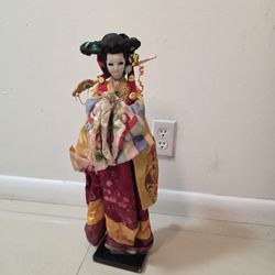 Una muñeca tradicional japonesa, una geisha vestida con un kimono de seda. 21 pulgadas de alto x 9 pulgadas de ancho.