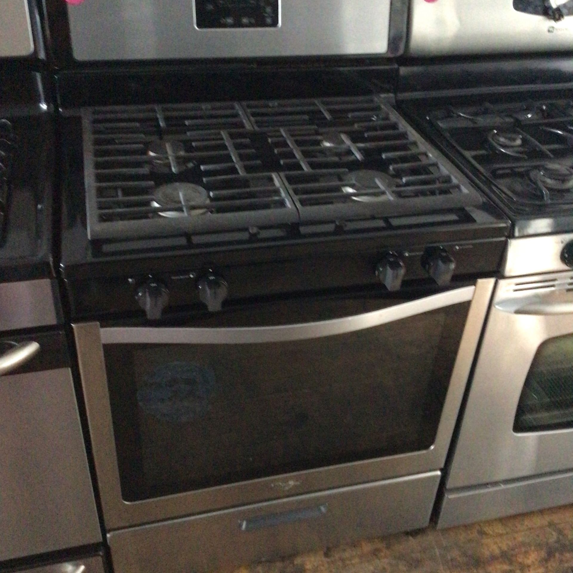 Whirlpool black and stainless steel four burner gas stove