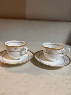 White with gold trim and gold scrollwork tea cups and saucers