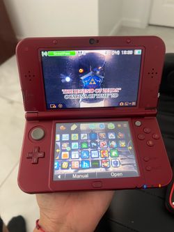 For sale: Red New 3DS XL, already hacked. Includes a 128GB SD card, a built-in shop for downloading any game, the original charger, and a carrying cas